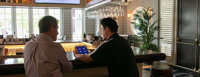 a man looking at an ipad